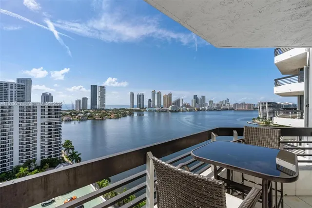 a view of swimming pool with outdoor seating and lake view