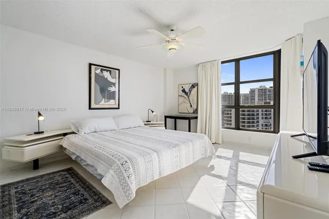 a bedroom with a bed and a large window