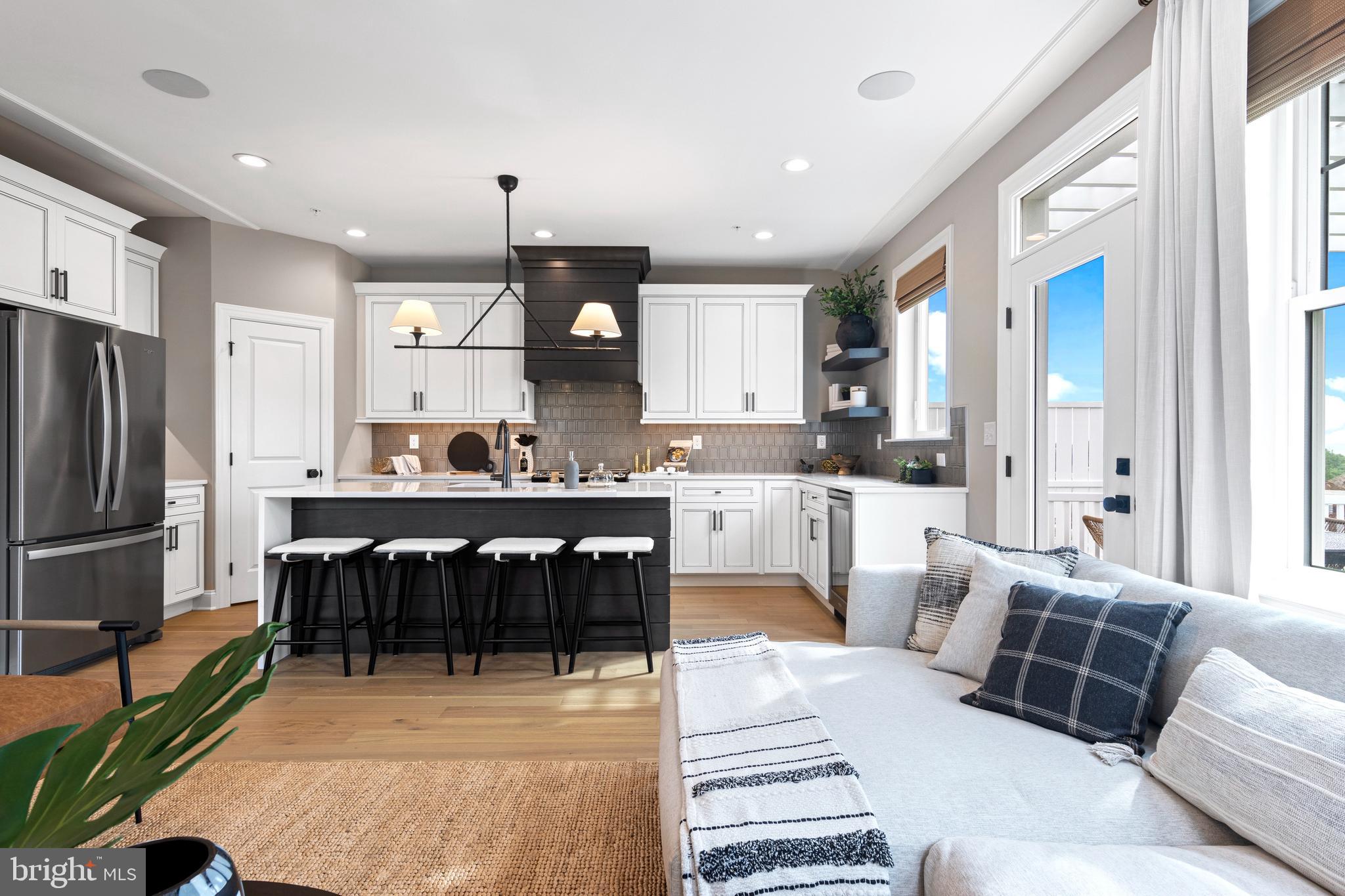a living room with furniture a fireplace and a large window