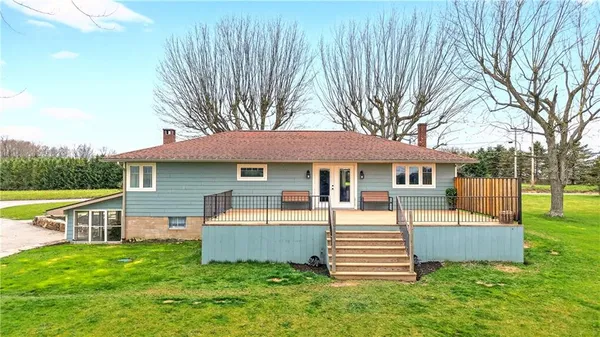 a view of a house with a backyard