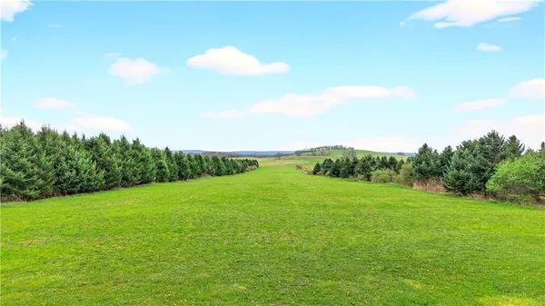 an aerial view of a residential houses with outdoor space and city view