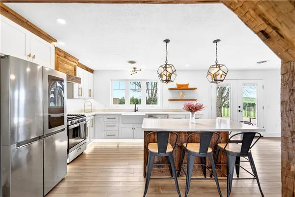 a kitchen with a stove sink and window