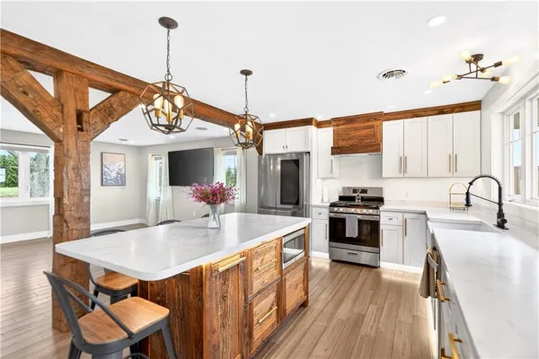 a kitchen with stainless steel appliances granite countertop a sink stove and refrigerator