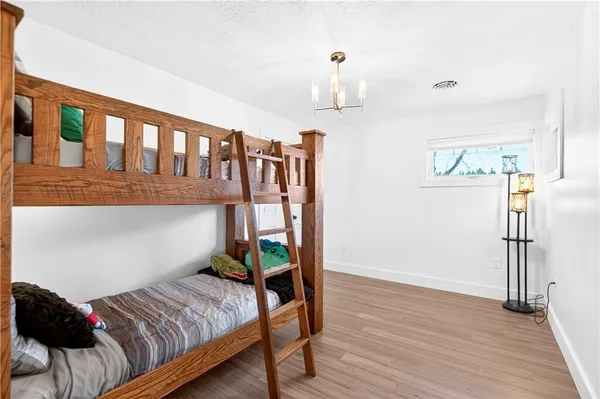 a bedroom with furniture and wooden floor