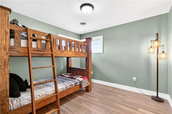 a bedroom with a bed and a mirror