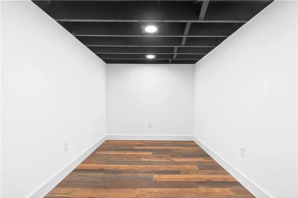 a spacious bathroom with a tub and glass windows