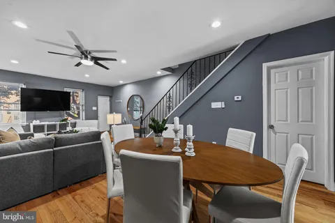 a living room with furniture kitchen view and a flat screen tv