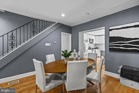 a view of a dining room with furniture and a window