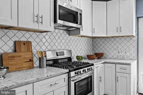 a kitchen with granite countertop a stove and a sink