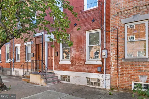 a front view of a building with a garden