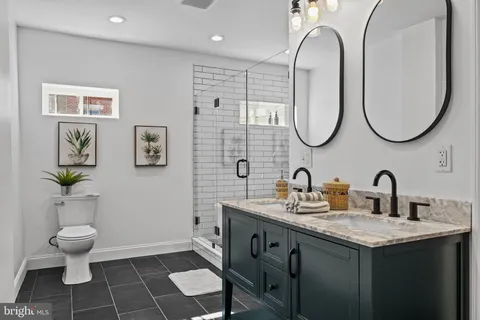 a bathroom with a toilet sink and mirror