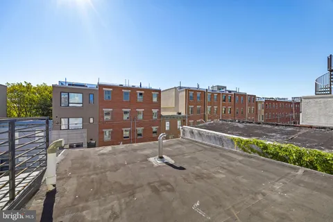 a view of a house with a bench in front of it