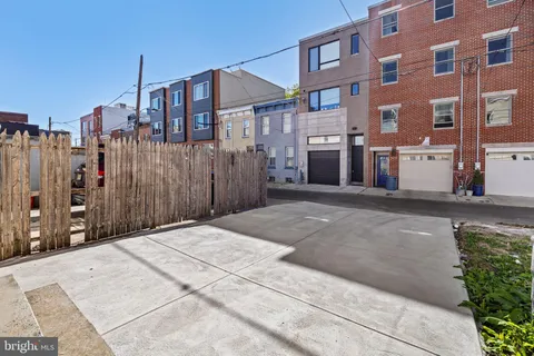 front view of a brick house with large windows