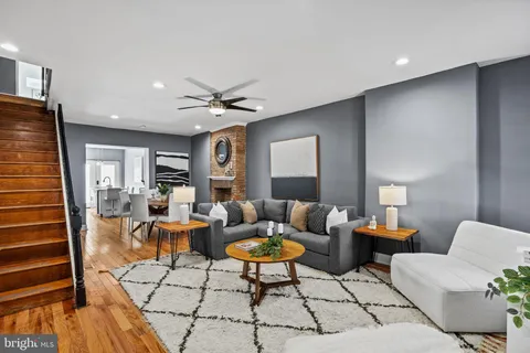 a living room with furniture a rug and a chandelier