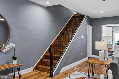 a view of an entryway with wooden floor and stairs