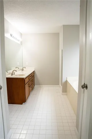 a bath tub sitting in a bathroom next to a toilet