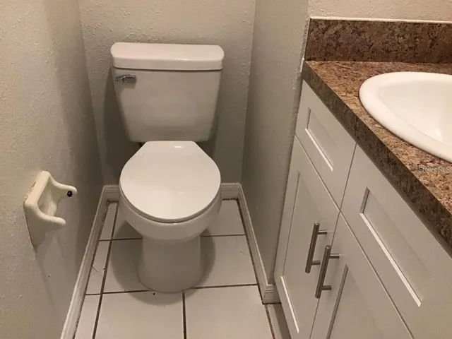 a bathroom with a toilet and a mirror
