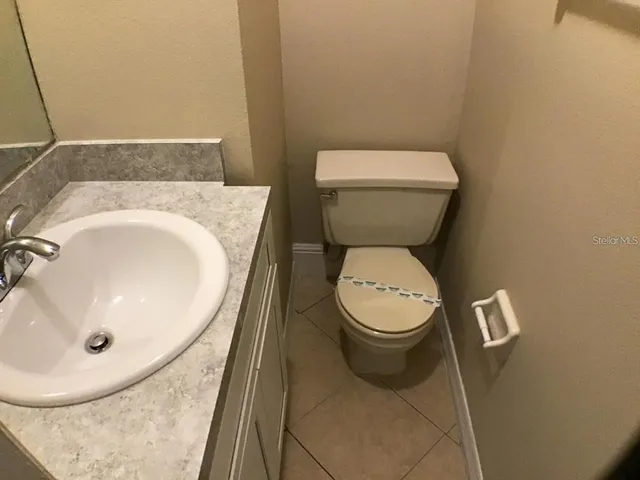a white toilet sitting next to a white sink