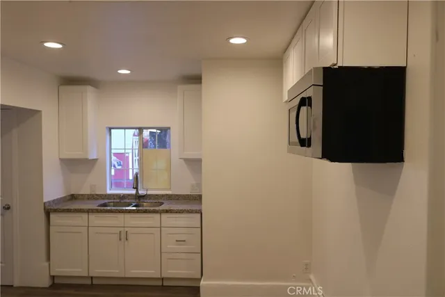 a kitchen with stainless steel appliances a refrigerator and a stove