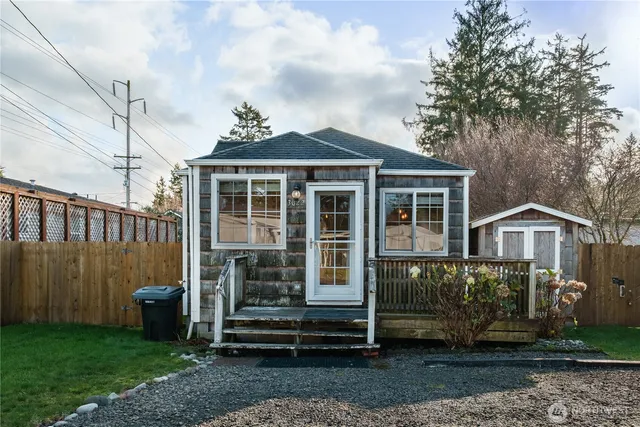 a front view of a house with a garden