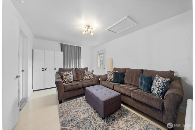 a living room with furniture and a chandelier