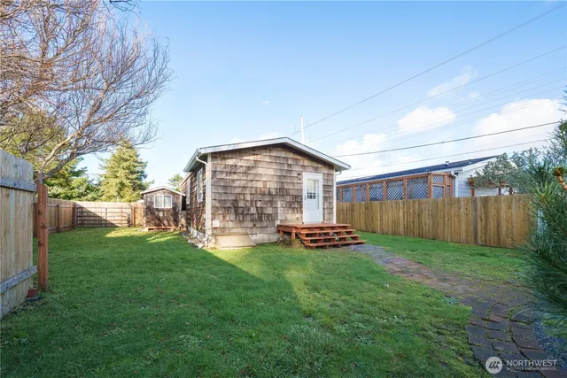 a backyard of a house with barbeque oven