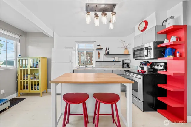 a kitchen with stainless steel appliances granite countertop a sink and a refrigerator