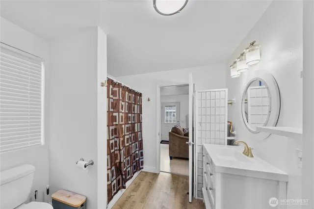 a bathroom with a sink a toilet and shower