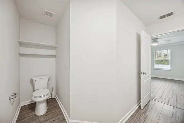 a view of an empty room with wooden floor