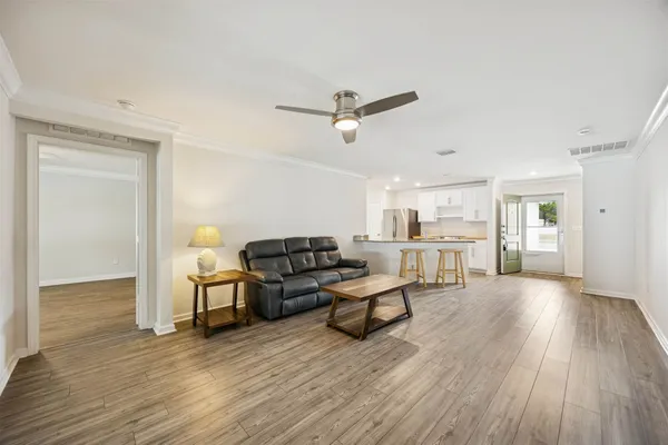 a view of a livingroom with furniture and a ceiling fan