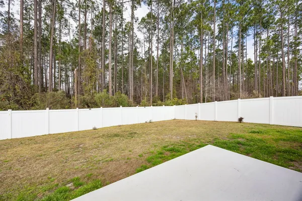 a living room with patio furniture and a large window