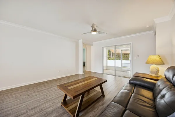 a kitchen with granite countertop white cabinets and a wooden floor