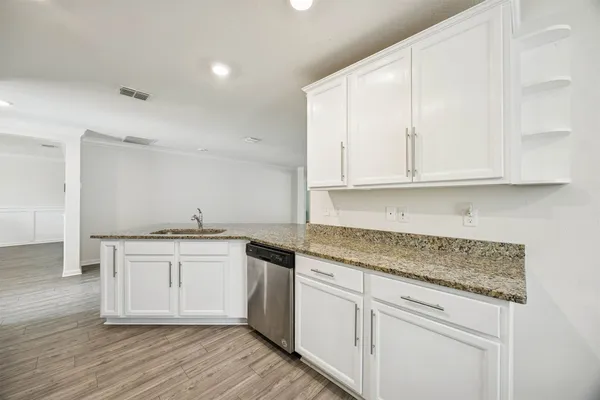 a kitchen with refrigerator and cabinets