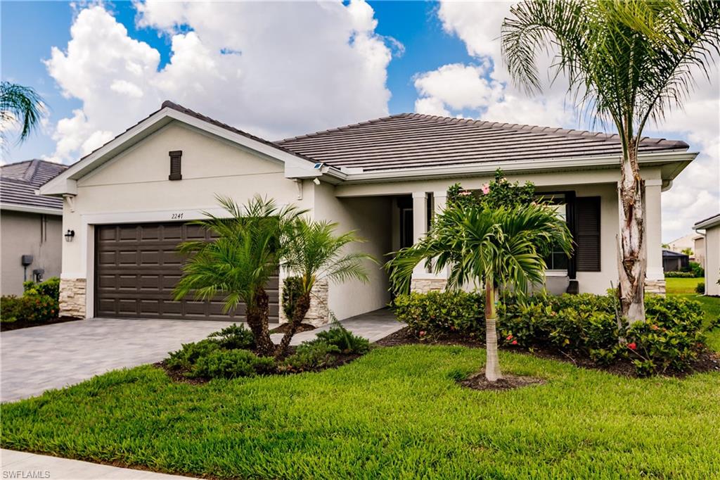 a front view of house with a garden