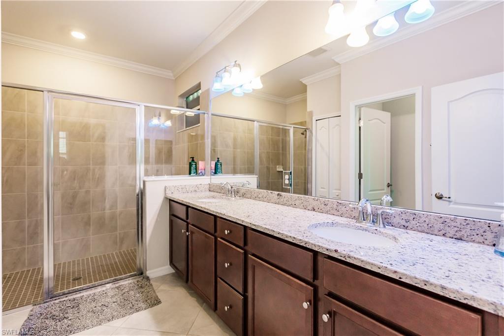 2247 Dancy Street Naples, FL 34120 - Photo 15 of 32 a bathroom with a granite countertop sink shower and a mirror