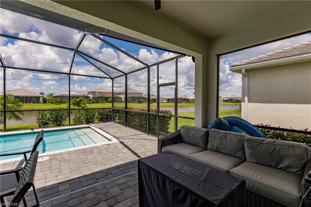 2247 Dancy Street Naples, FL 34120 - Photo 22 of 32 a living room with a couch and a table