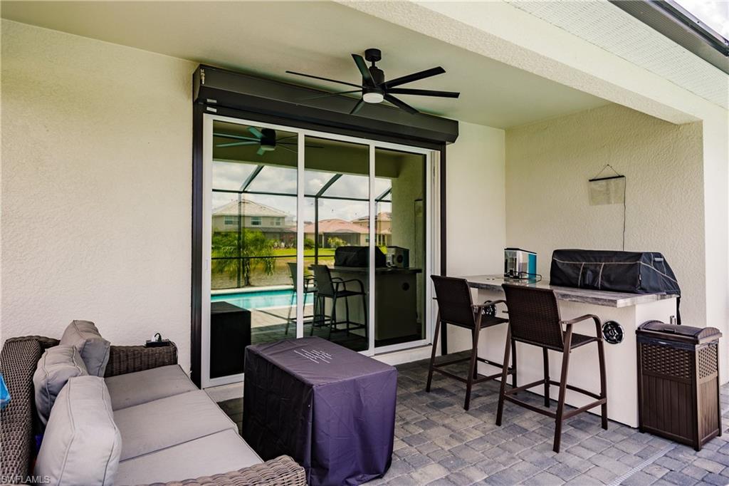 2247 Dancy Street Naples, FL 34120 - Photo 23 of 32 a living room with furniture and a large window