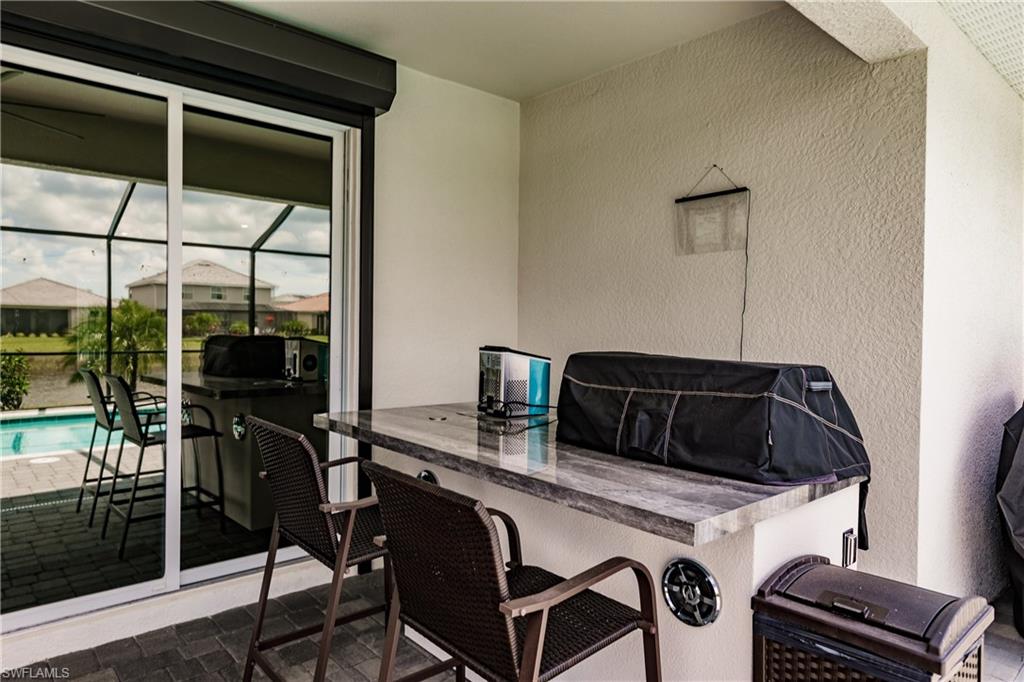 2247 Dancy Street Naples, FL 34120 - Photo 24 of 32 a kitchen with a table and chairs