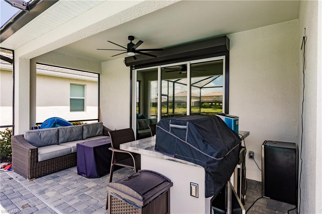 2247 Dancy Street Naples, FL 34120 - Photo 25 of 32 a living room with furniture and a window