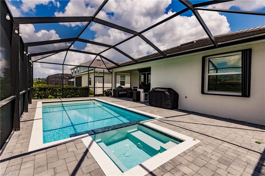 2247 Dancy Street Naples, FL 34120 - Photo 29 of 32 a view of a patio with a table and chairs under an umbrella