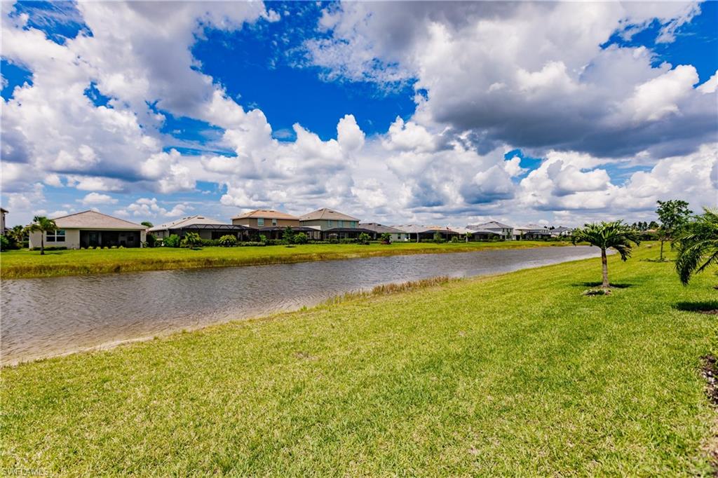 2247 Dancy Street Naples, FL 34120 - Photo 30 of 32 a view of a lake with houses in the background