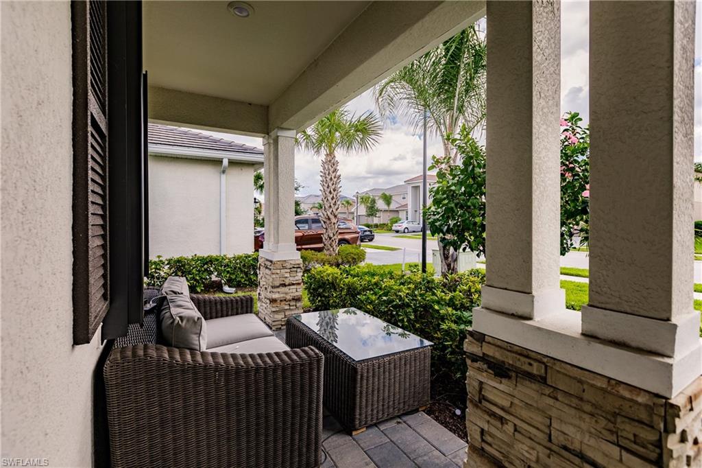 2247 Dancy Street Naples, FL 34120 - Photo 5 of 32 a view of a patio with couches plants and large tree
