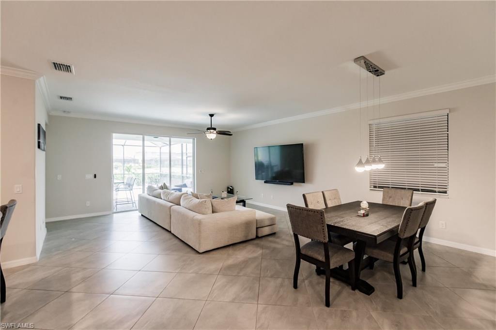 2247 Dancy Street Naples, FL 34120 - Photo 6 of 32 a living room with furniture a flat screen tv and a large window