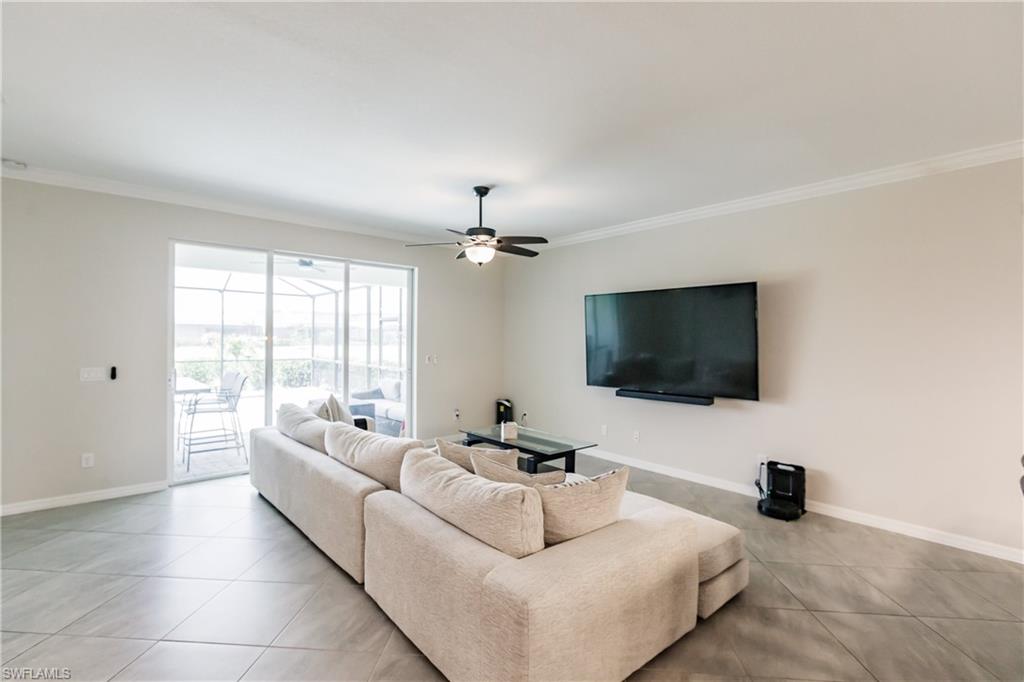 2247 Dancy Street Naples, FL 34120 - Photo 7 of 32 a living room with furniture and a flat screen tv