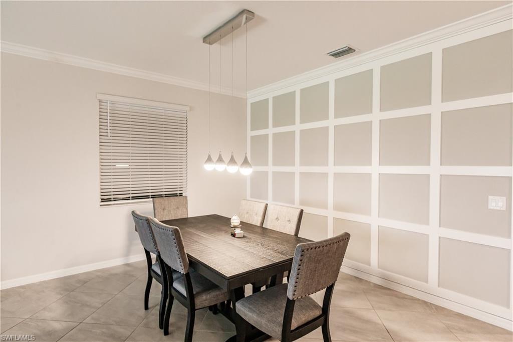 2247 Dancy Street Naples, FL 34120 - Photo 9 of 32 a view of a dining room with a table and chairs