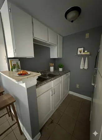 a kitchen with a sink cabinets and appliances