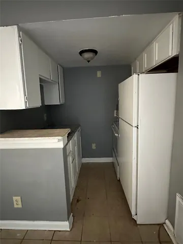 a utility room with cabinets washer and dryer