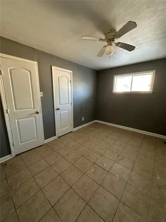 en empty room with windows and closet