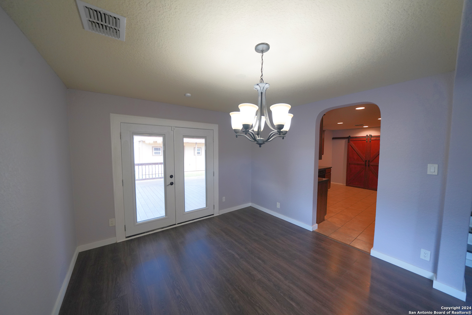 523 Diana Drive Converse, TX 78109 - Photo 13 of 50 a view of a room with wooden floor and chandelier