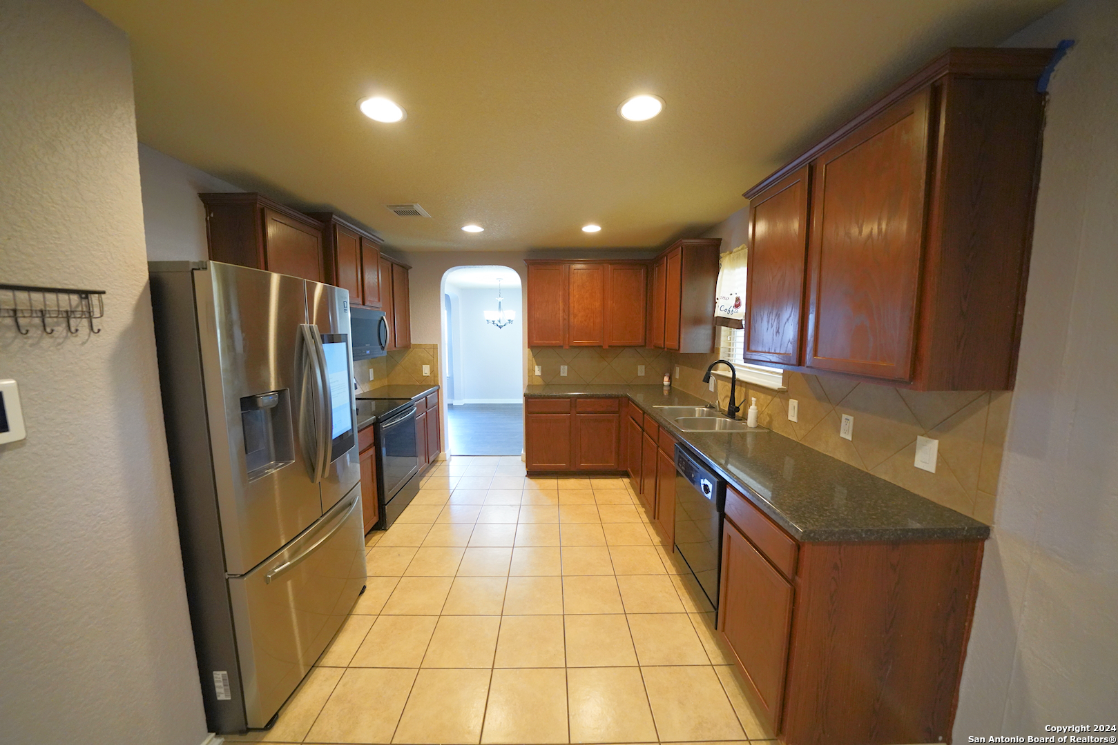 523 Diana Drive Converse, TX 78109 - Photo 16 of 50 a kitchen with stainless steel appliances granite countertop a refrigerator and a sink